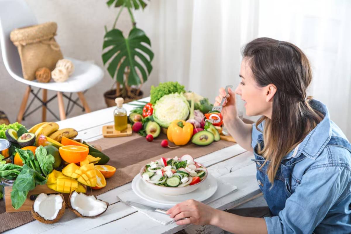A table filled with colorful fruits and vegetables, with a person enjoying a fresh salad, surrounded by healthy ingredients.